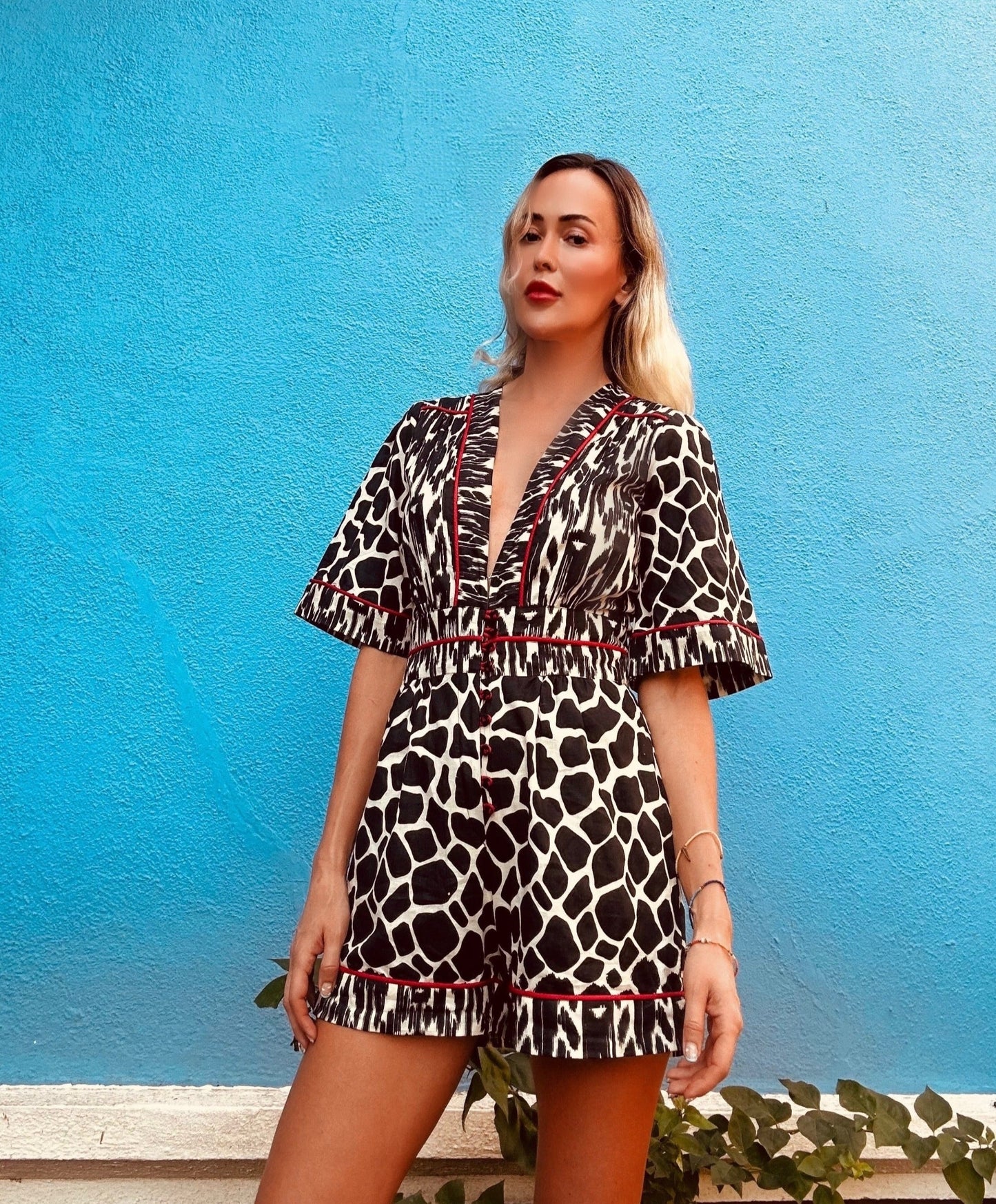 Plunging neckline romper in animal print with side pockets