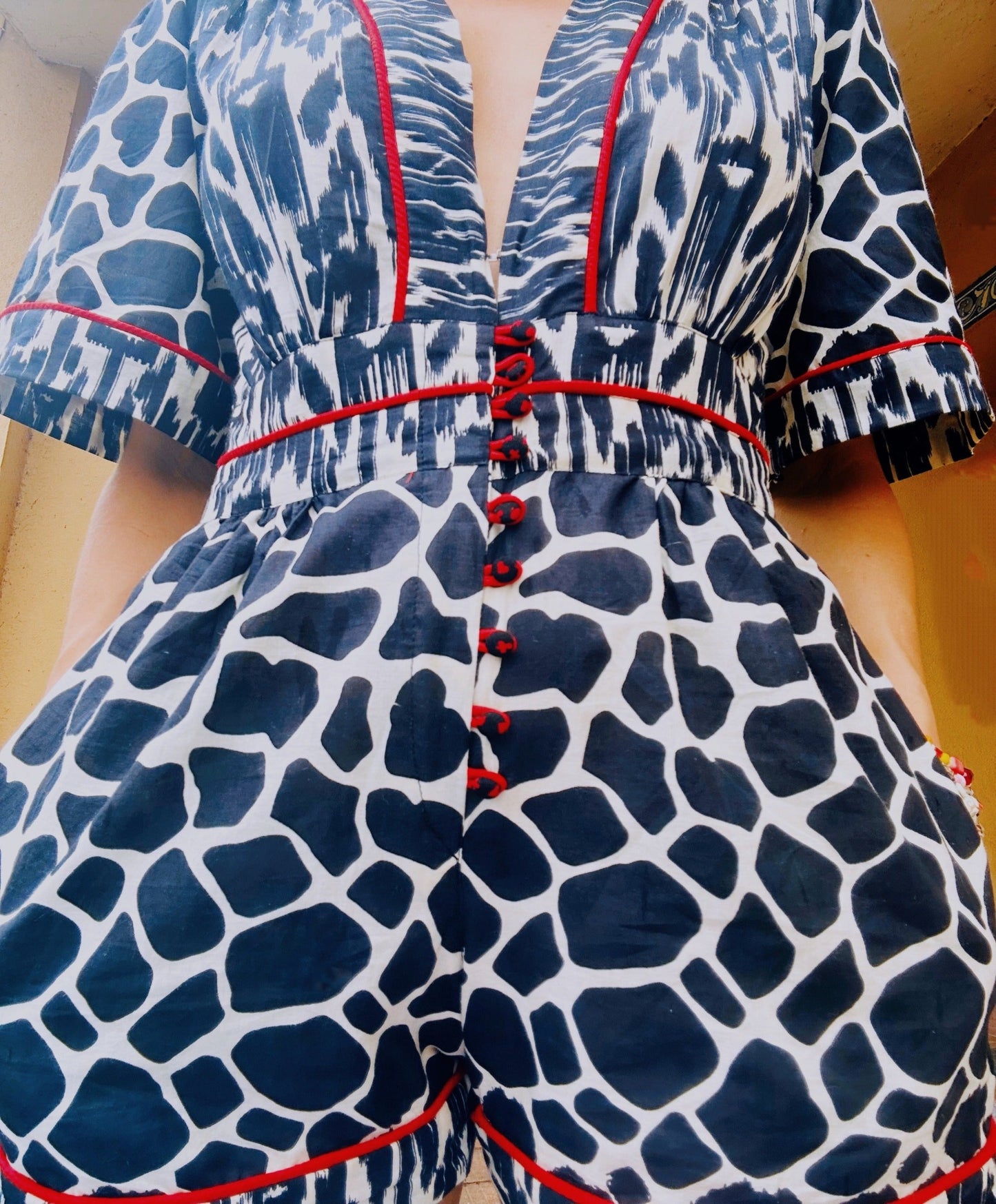 Plunging neckline romper in animal print with side pockets